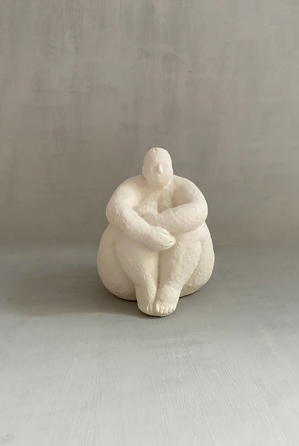Female ceramic sculpture on cement surface
