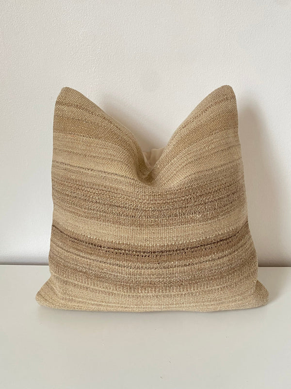 Textured beige Turkish Kilim pillow cover on a white background