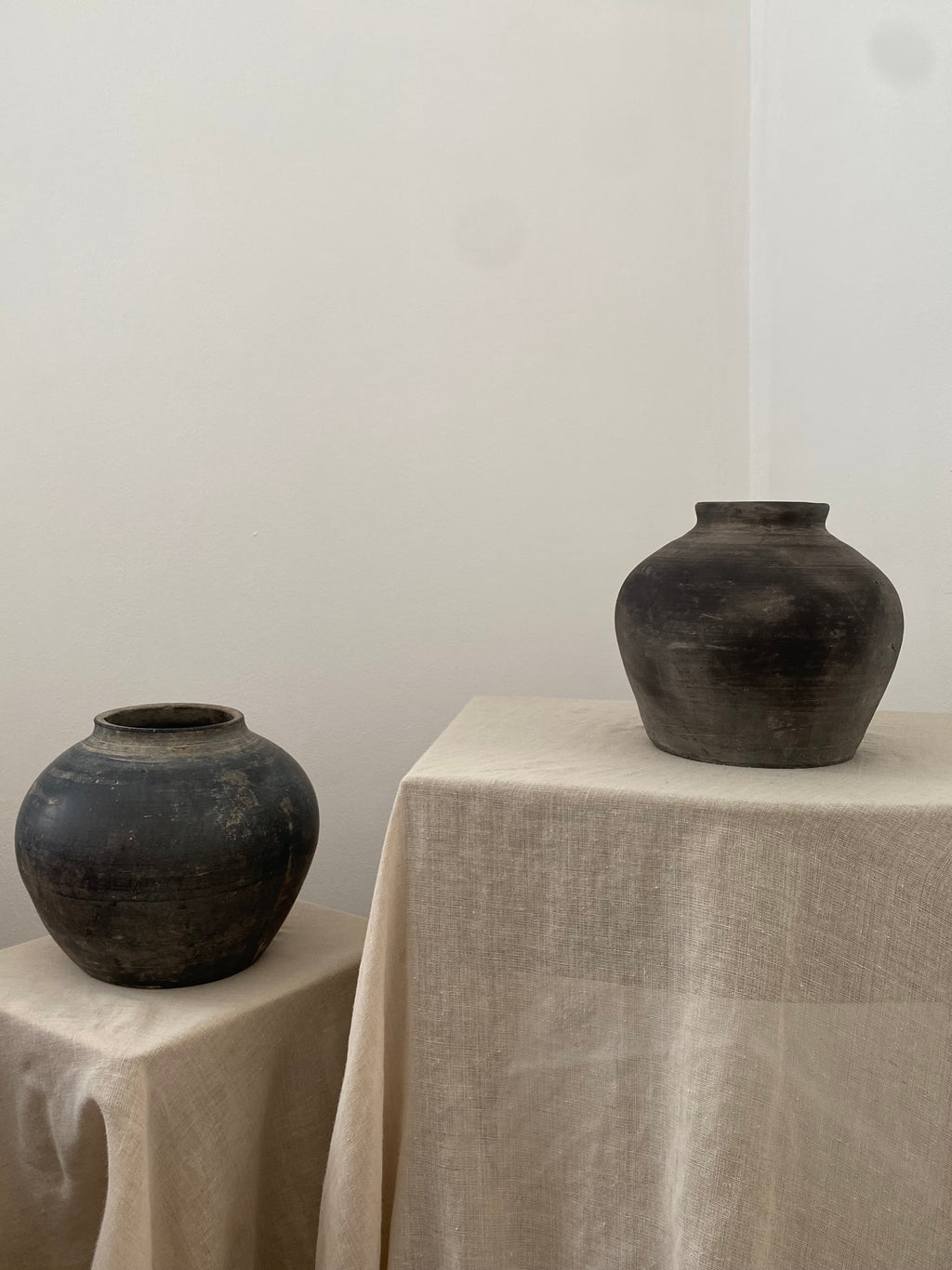 Two black antique clay pot on linen cloths