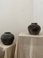 Two black antique clay pot on linen cloths