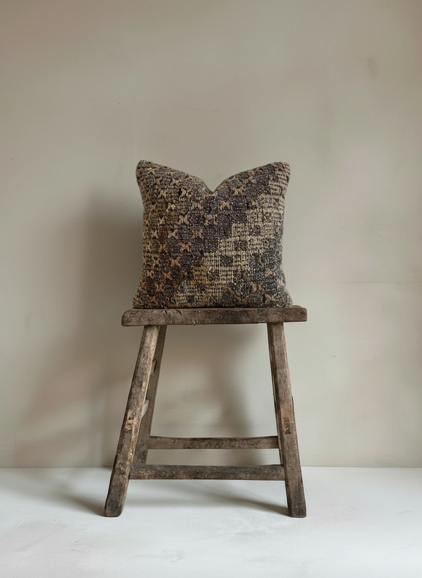 Close-up of patterned Turkish Kilim Pillow Cover  on rustic stool