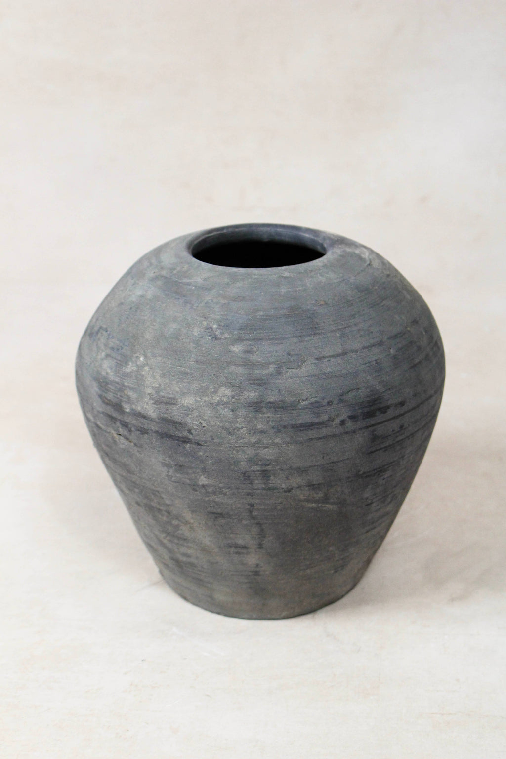 Grey antique terracotta clay pot on a white background