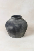 Black grey clay pot on a white background