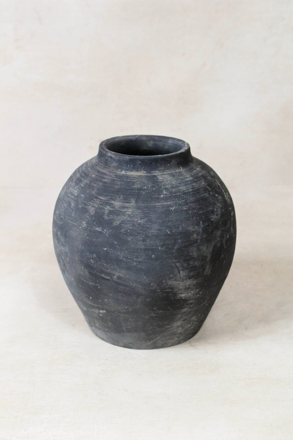 Black grey antique clay pot on a white background
