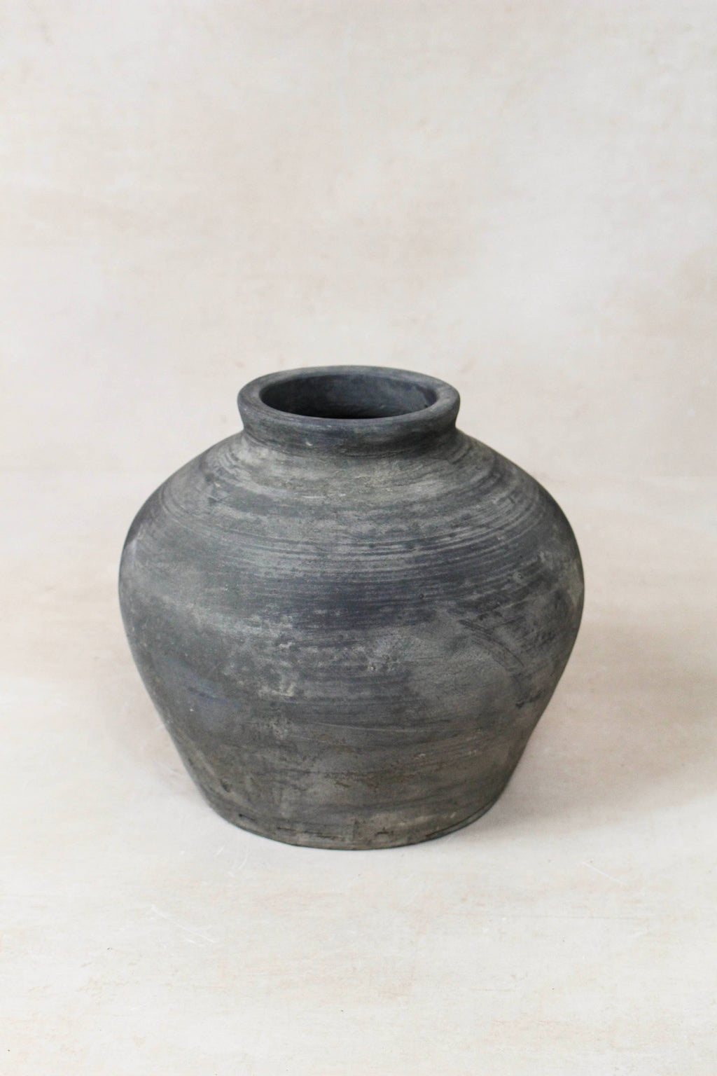 Black grey antique clay pot on a white background