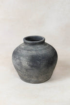 Black grey antique clay pot on a white background