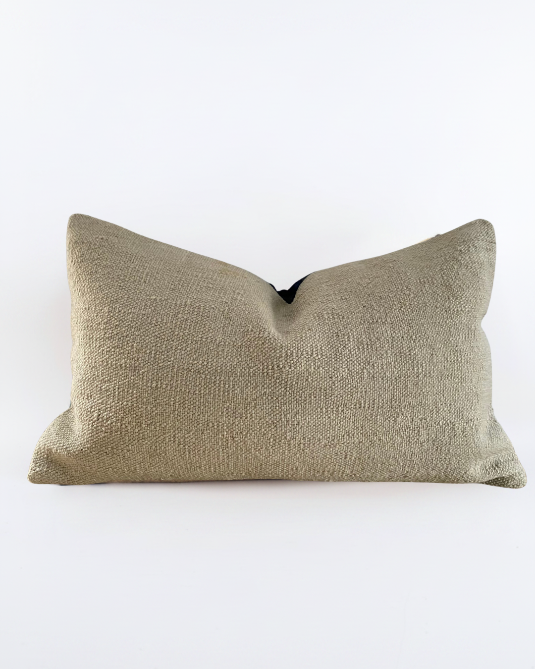 A rectangular Turkish Kilim lumbar pillow cover in a textured, woven taupe fabric, photographed against a seamless white background.