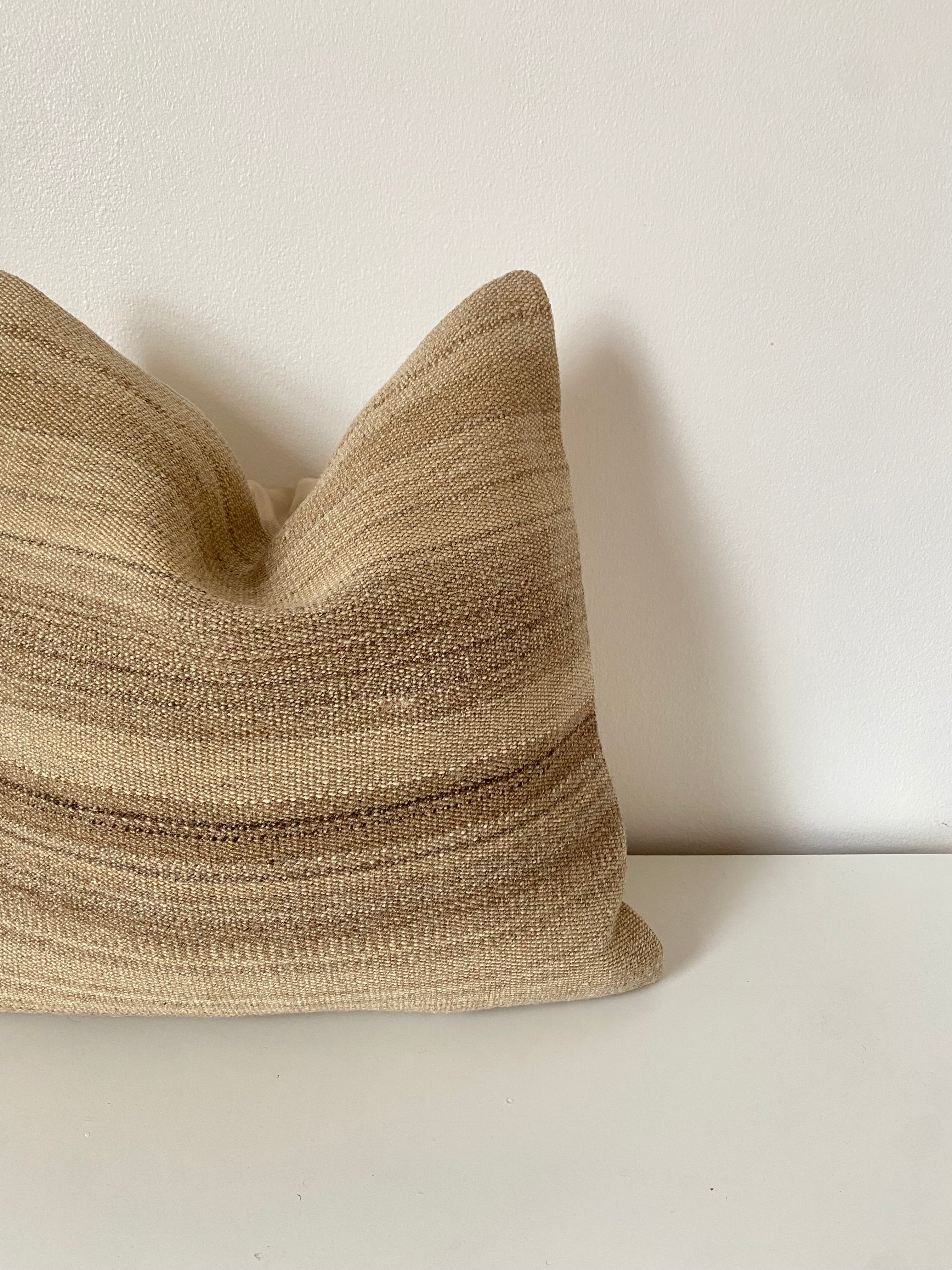 Textured beige Turkish pillow cover on a white background