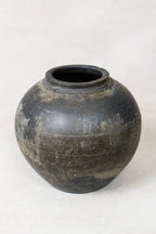 Black earthenware clay pot on a white background
