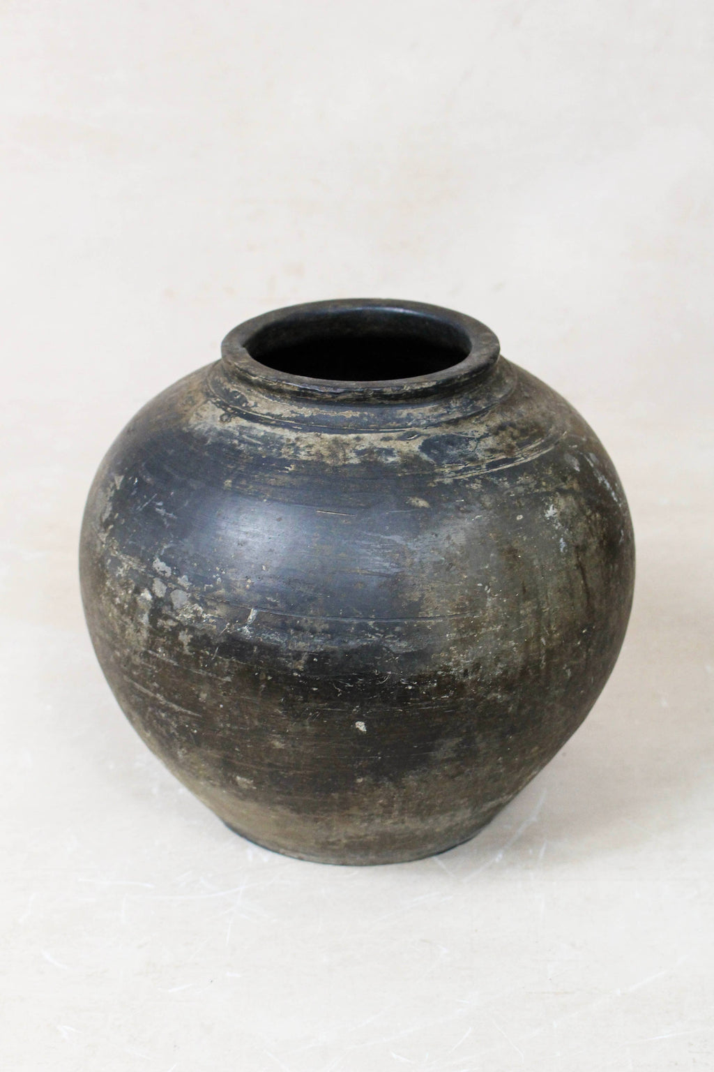 Black vintage terracotta urn on a white background