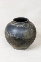 Black vintage terracotta urn on a white background