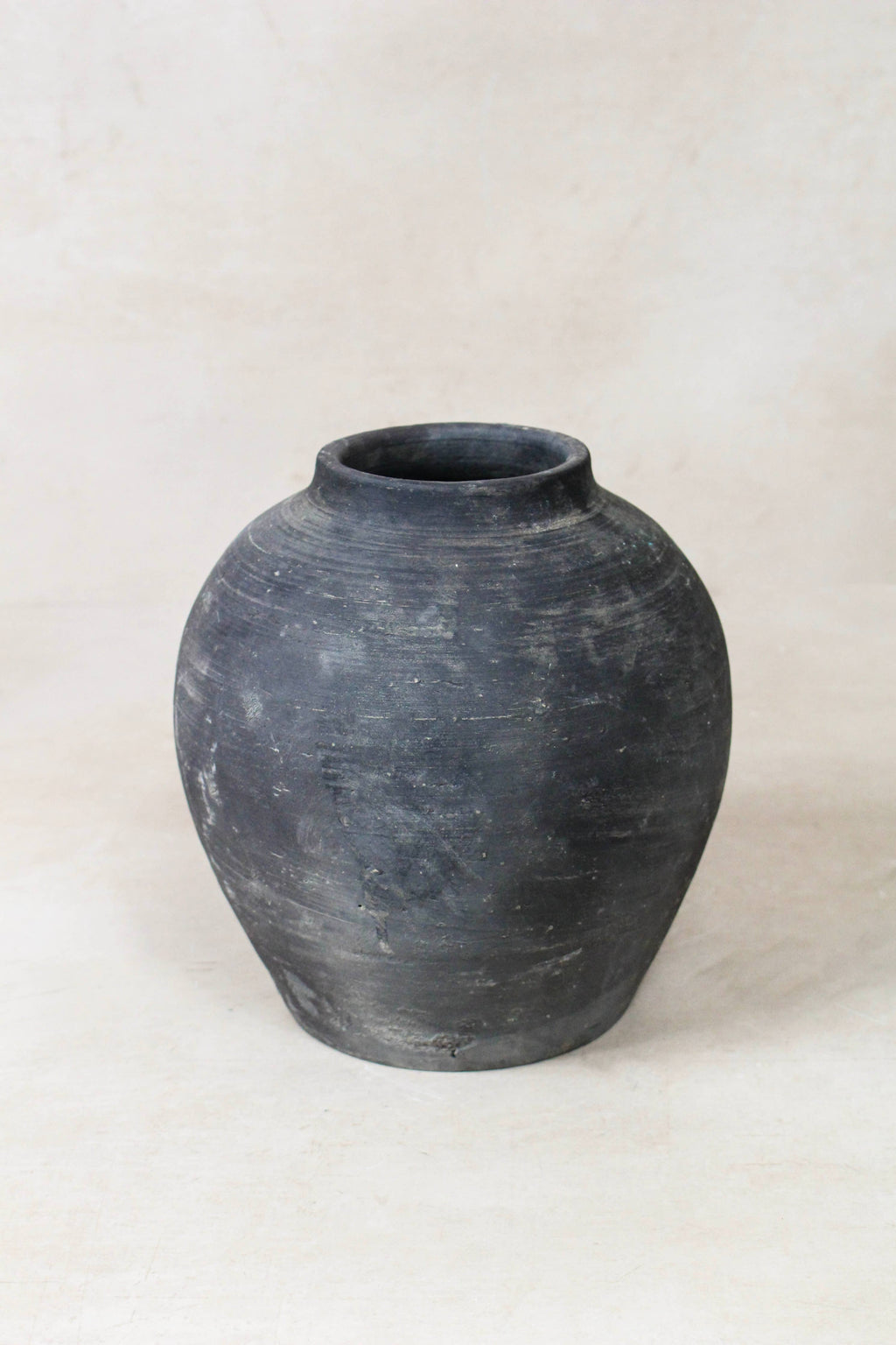 Black grey antique clay pot on a white background