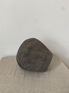 Dark gray antique clay pot  on a light beige linen cloth