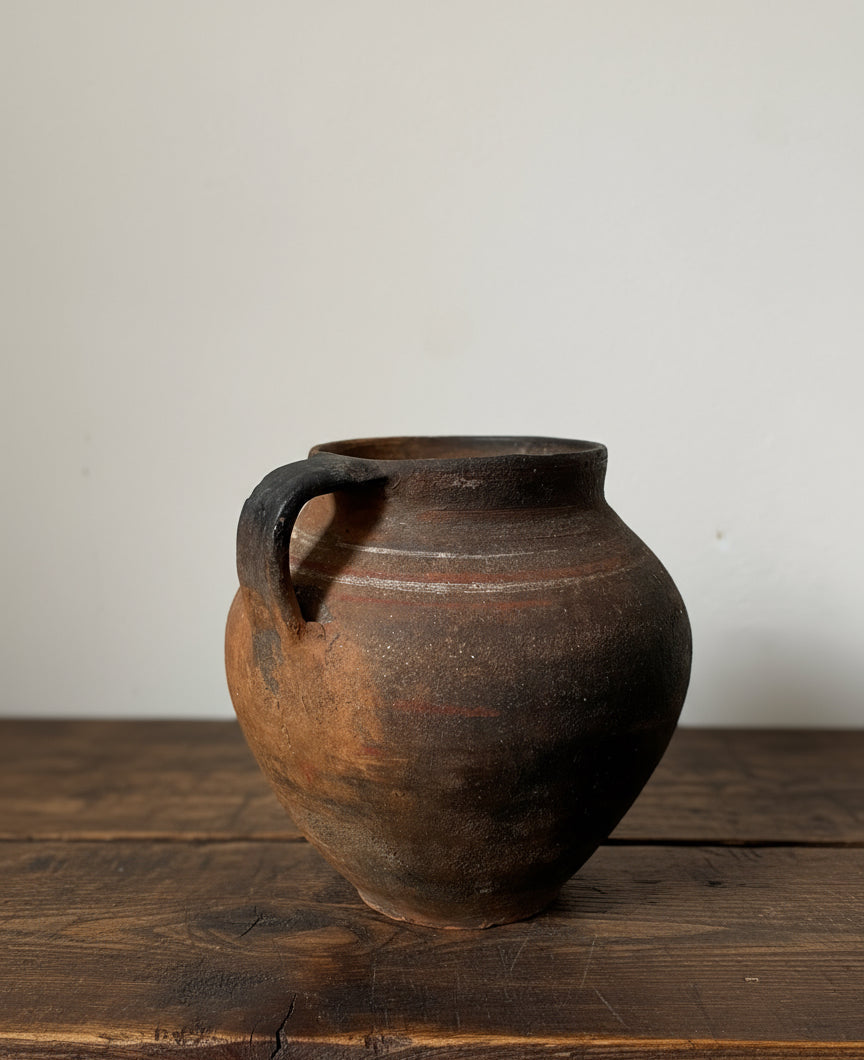 Brown ceramic vase on a light gray background