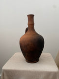 Brown antique terracotta clay pot on a linen  cloth