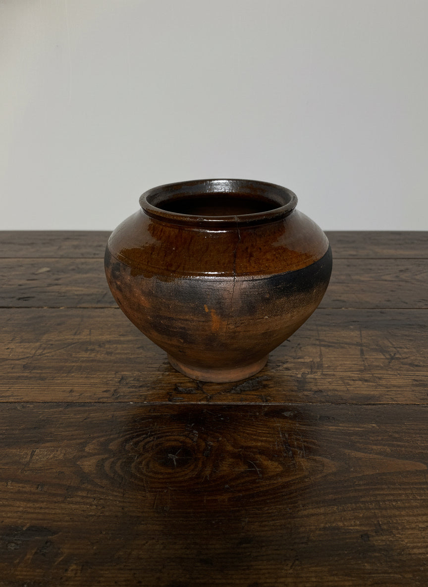 Brown antique terracotta clay pot on a white background