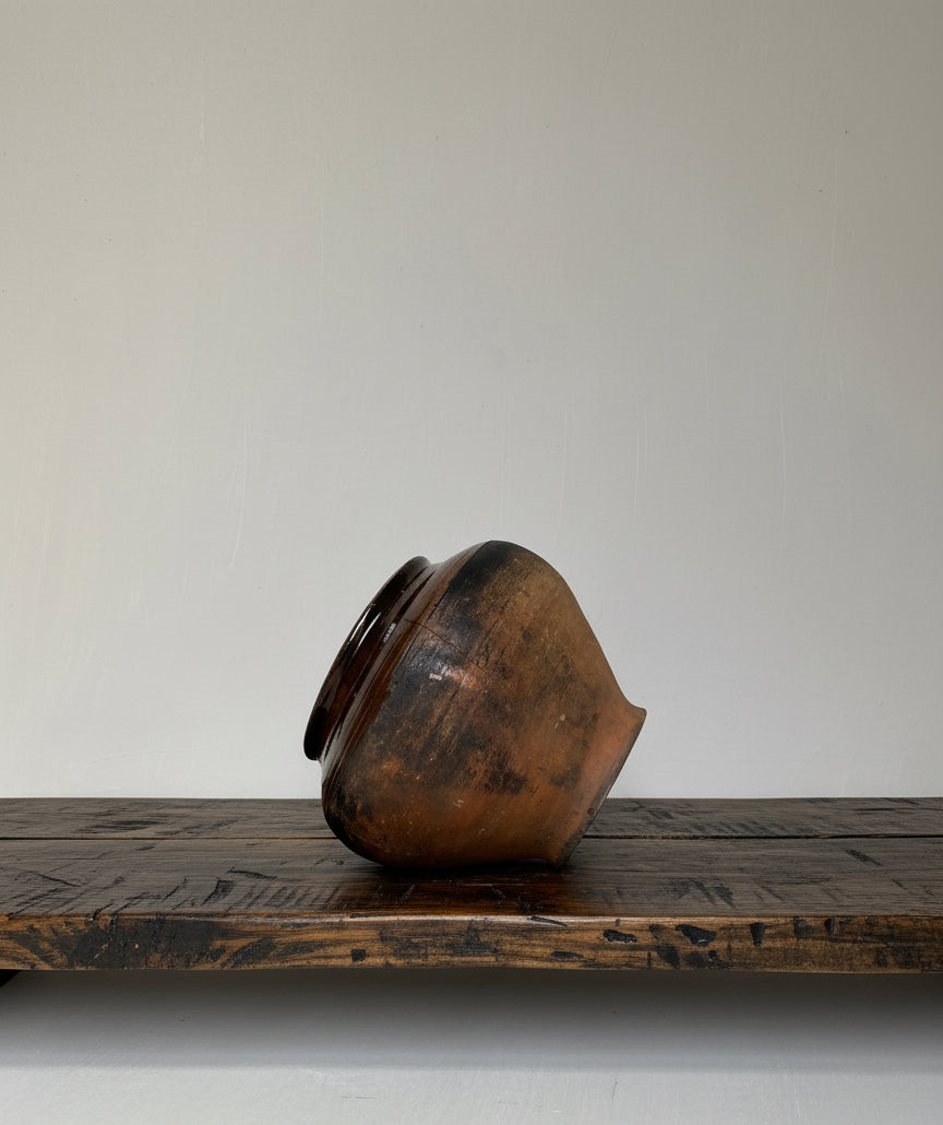 Brown antique clay pot on a white background