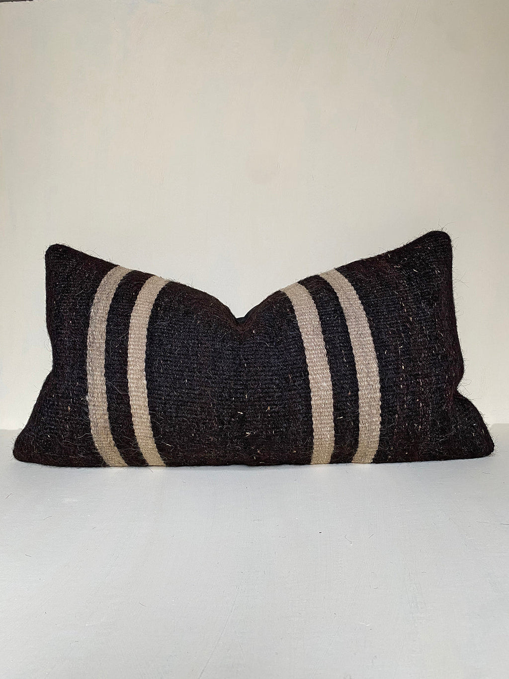 Vintage Turkish Kilim Pillow cover with black and beige stripes, handwoven from kilim wool with goat hair. Ideal for rustic interiors and neutral home styling.