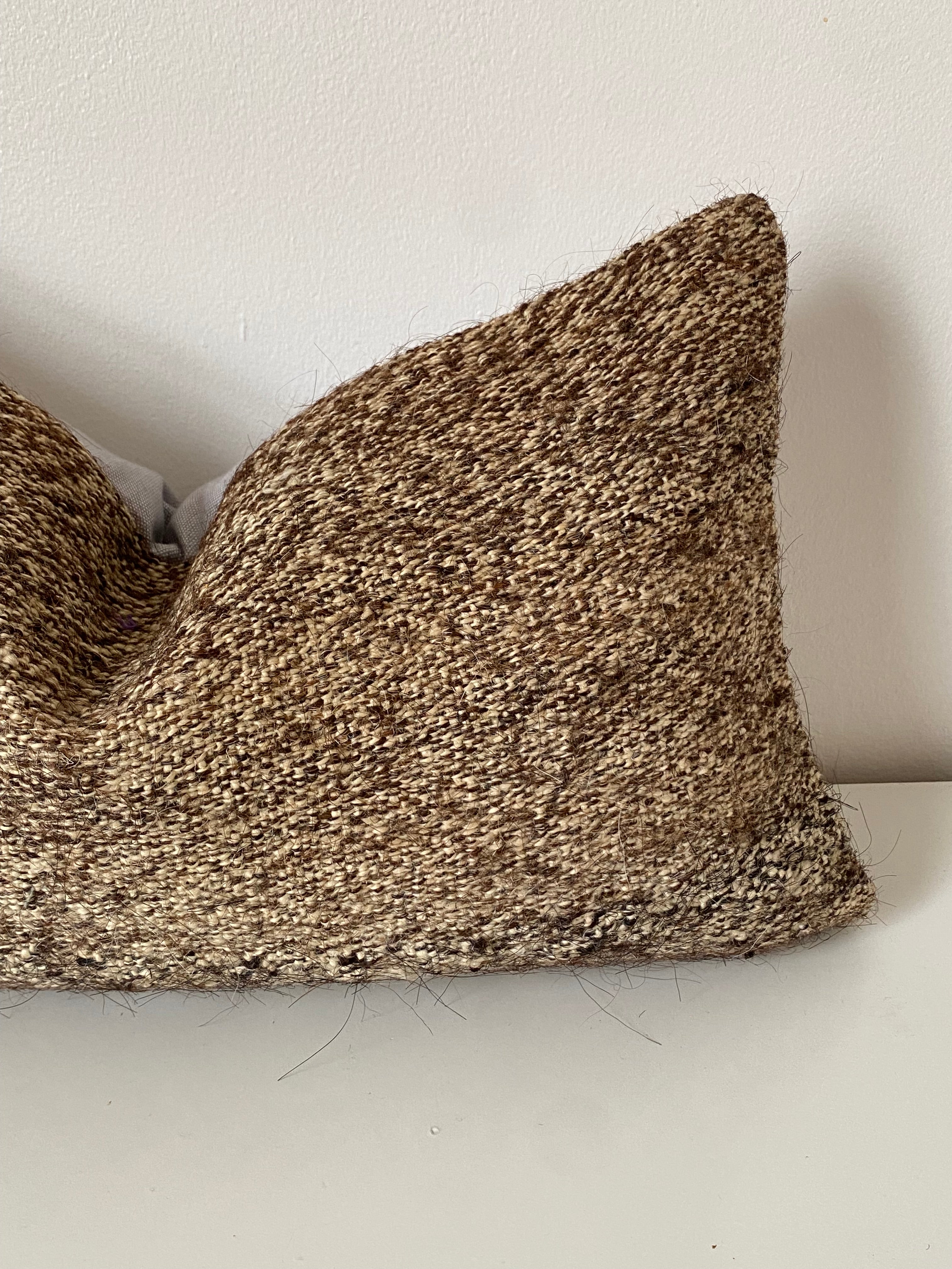 Textured brown Turkish pillow cover on a light grey surface