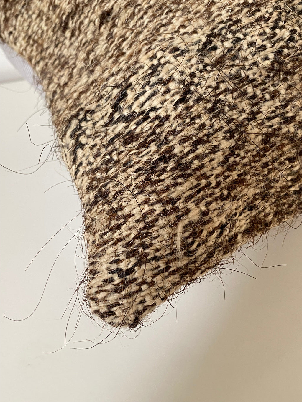 Close-up of textured Turkish Kilim Pillow cover with a neutral coloured background 