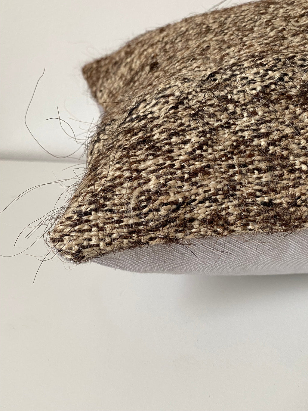 Textured Turkish Kilim pillow cover with a pattern on a plain background
