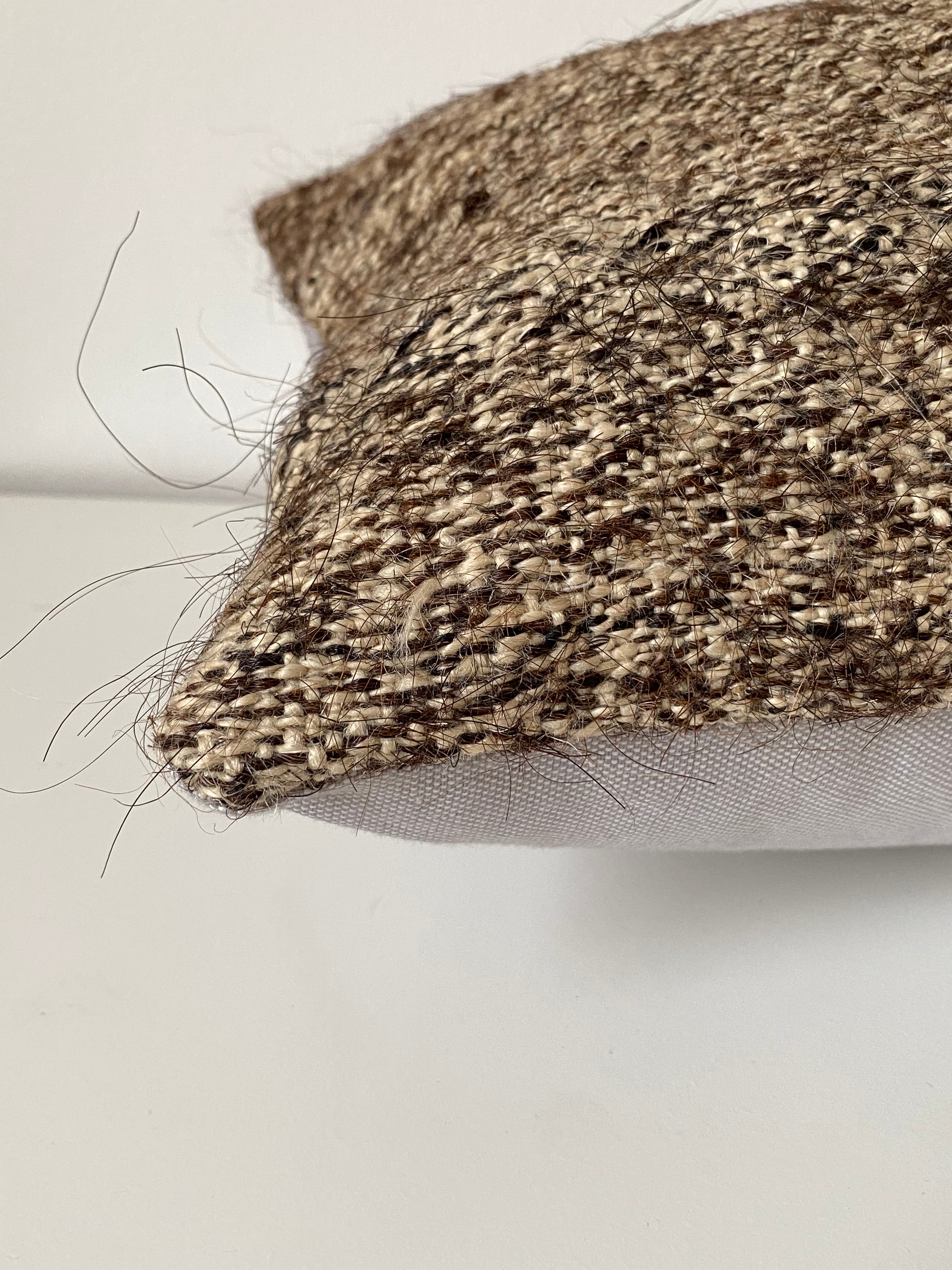 Textured Turkish Kilim pillow cover with a pattern on a plain background