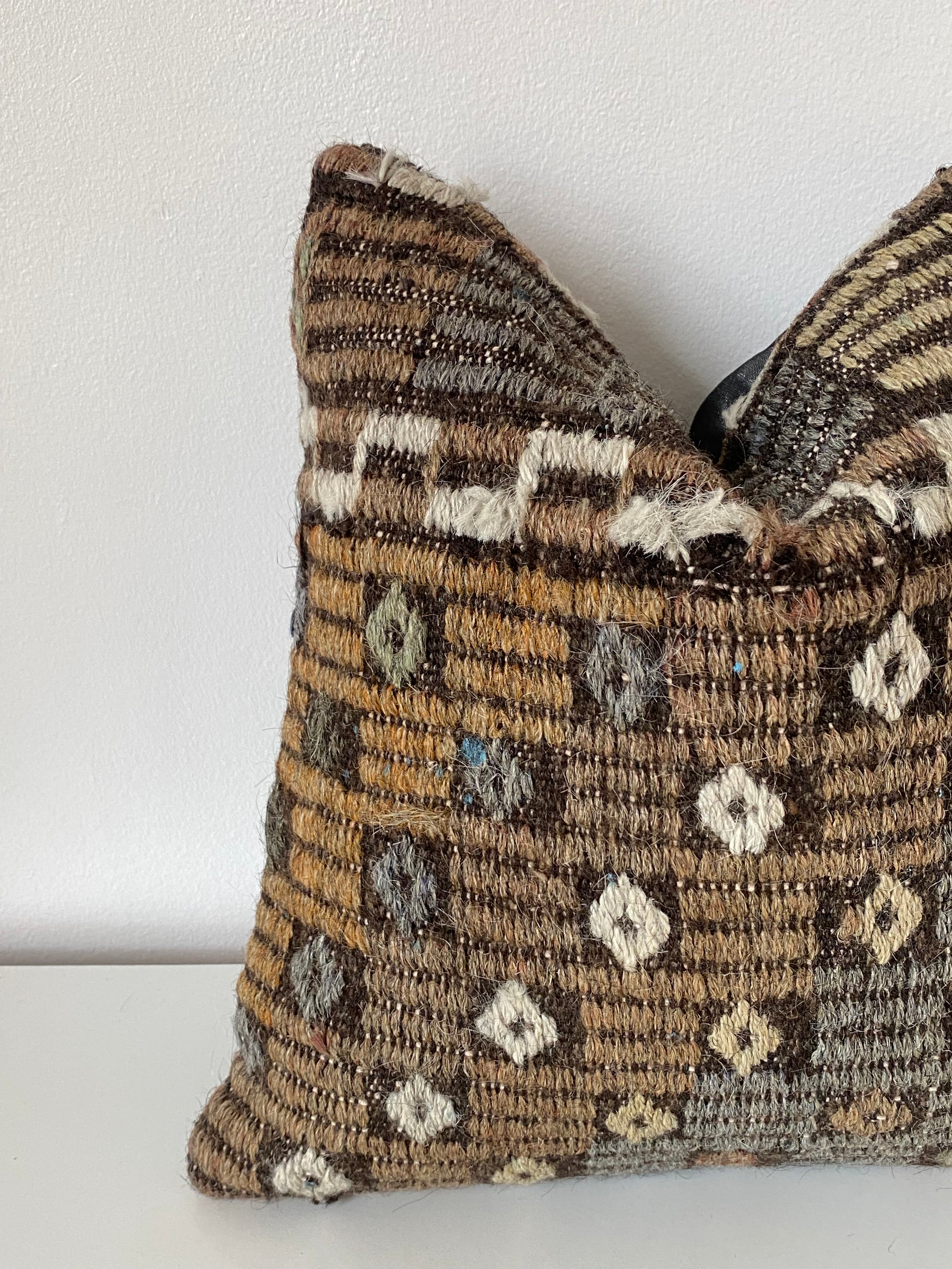 Textured Turkish kilim pillow cover with a geometric pattern on a white background