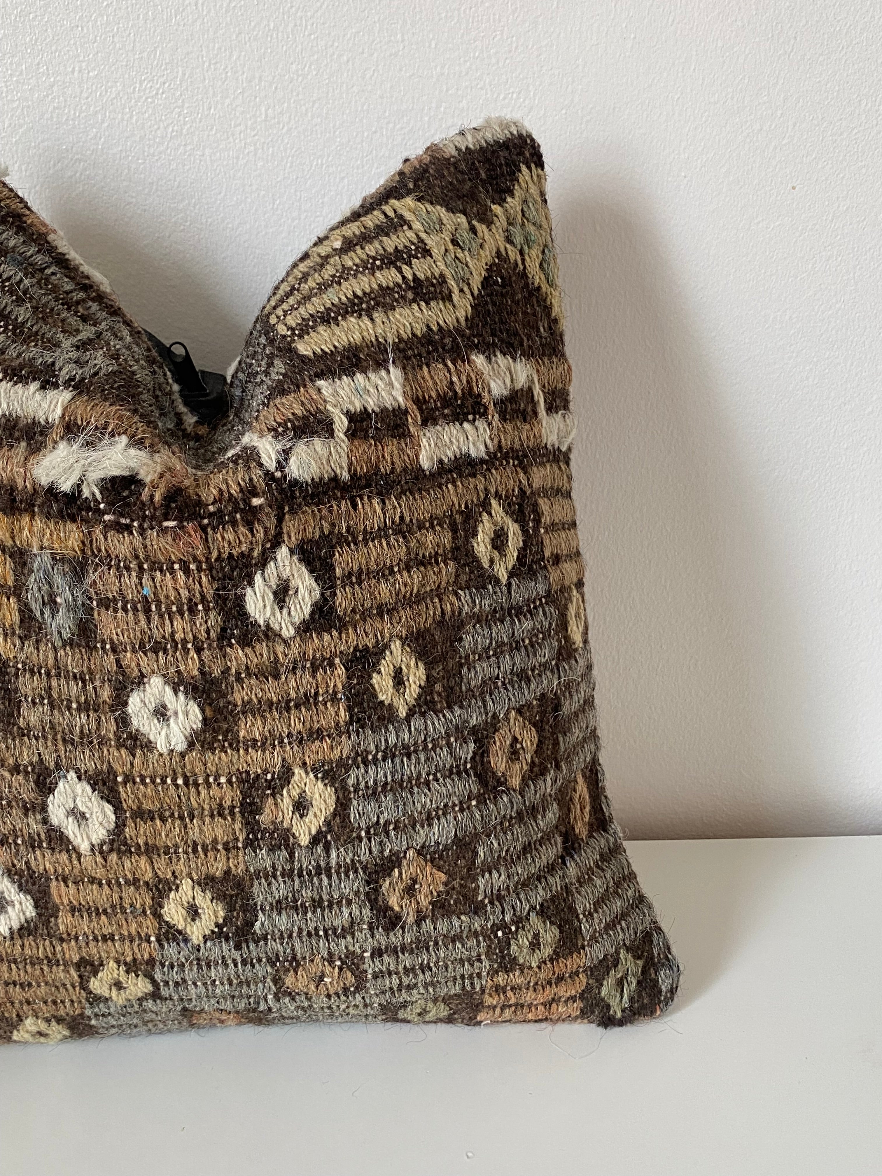 Textured Turkish kilim pillow cover with geometric pattern on a white background