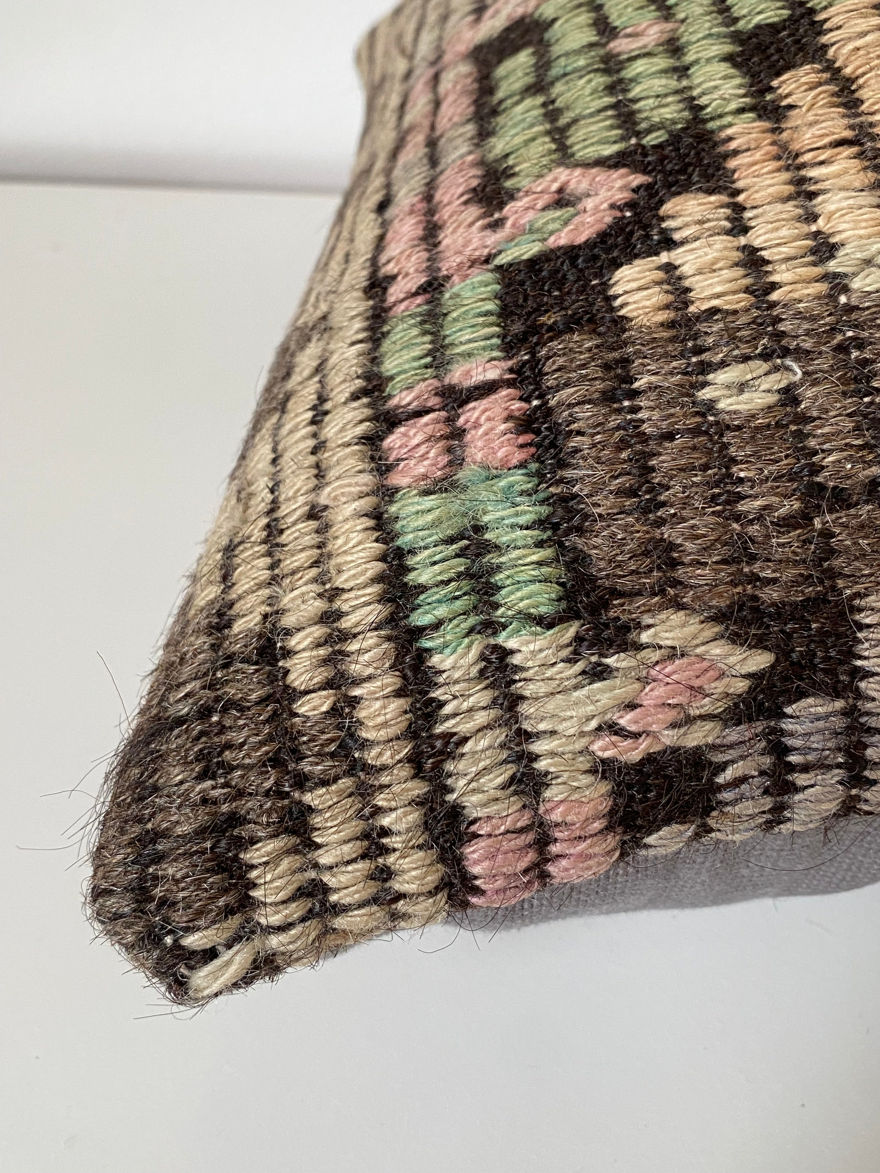 Close-up of a textured Turkish Pillow cover with geometric pattern on a white background