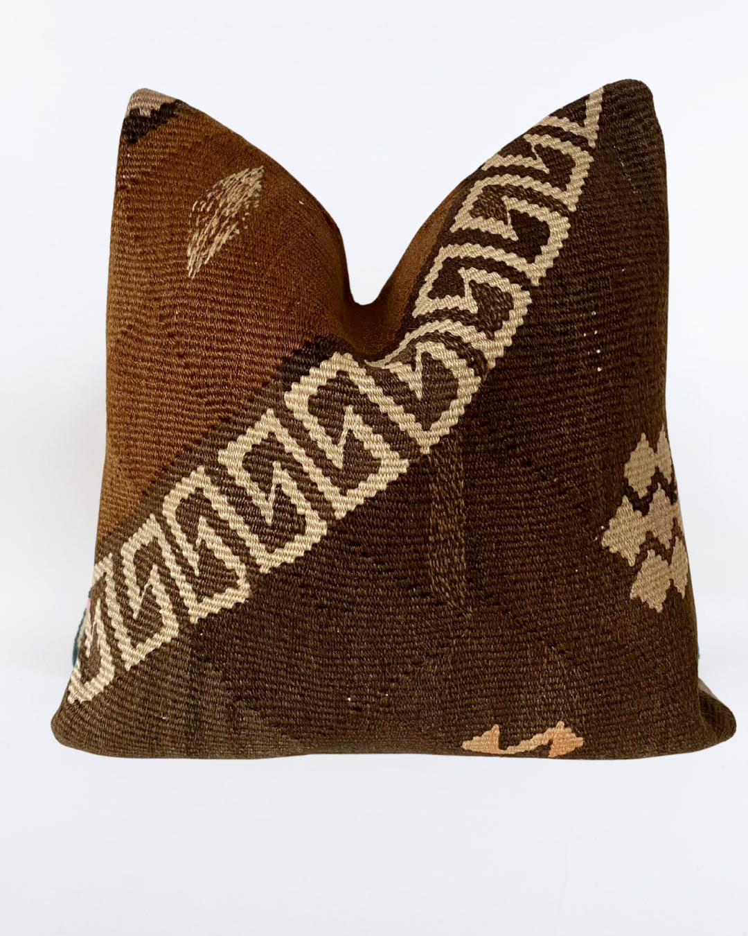 A square decorative brown Turkish Pillow cover made from a brown and beige woven kilim fabric with geometric patterns, shown against a plain white background.
