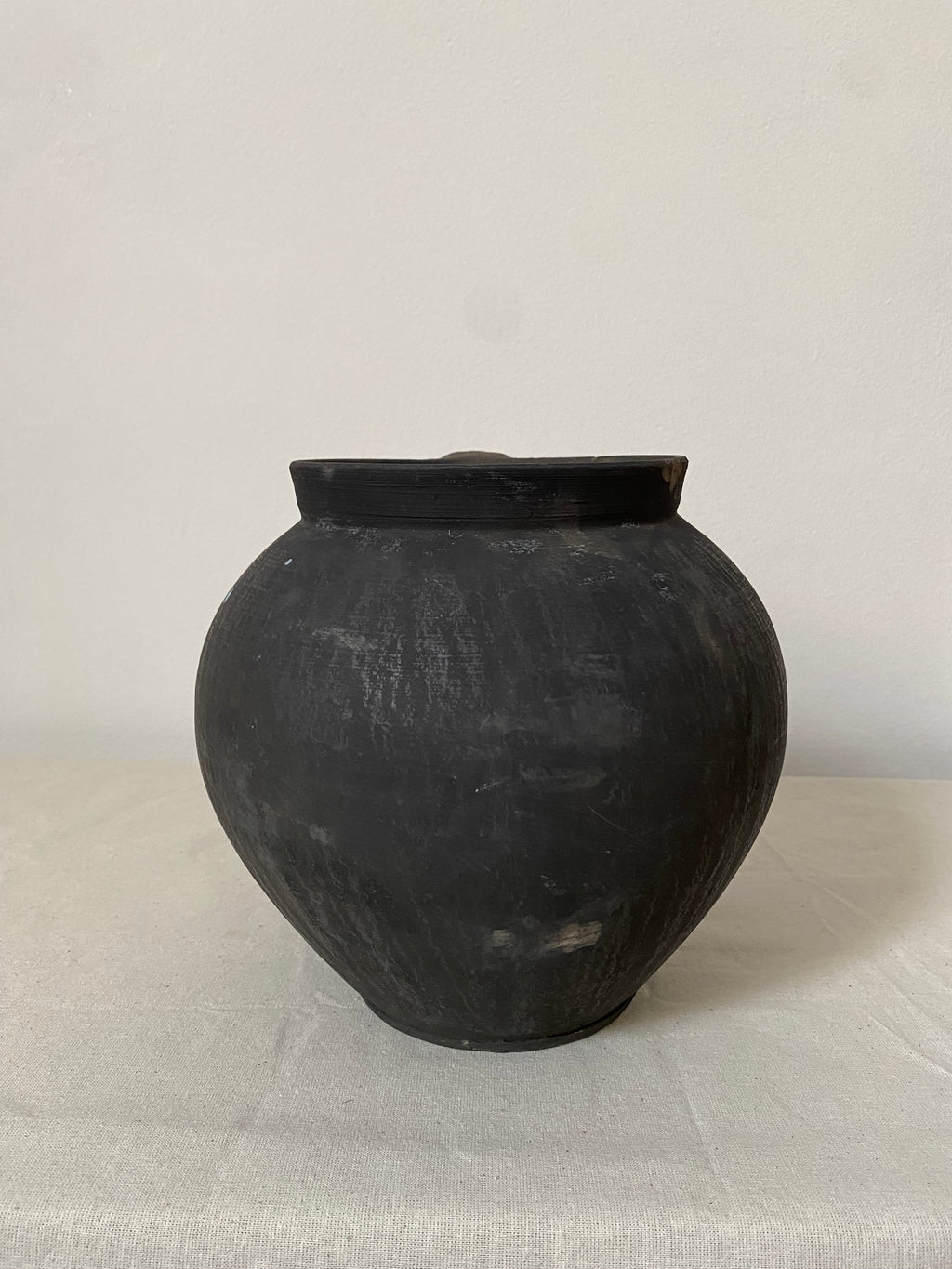 Black ceramic vase on a light gray background