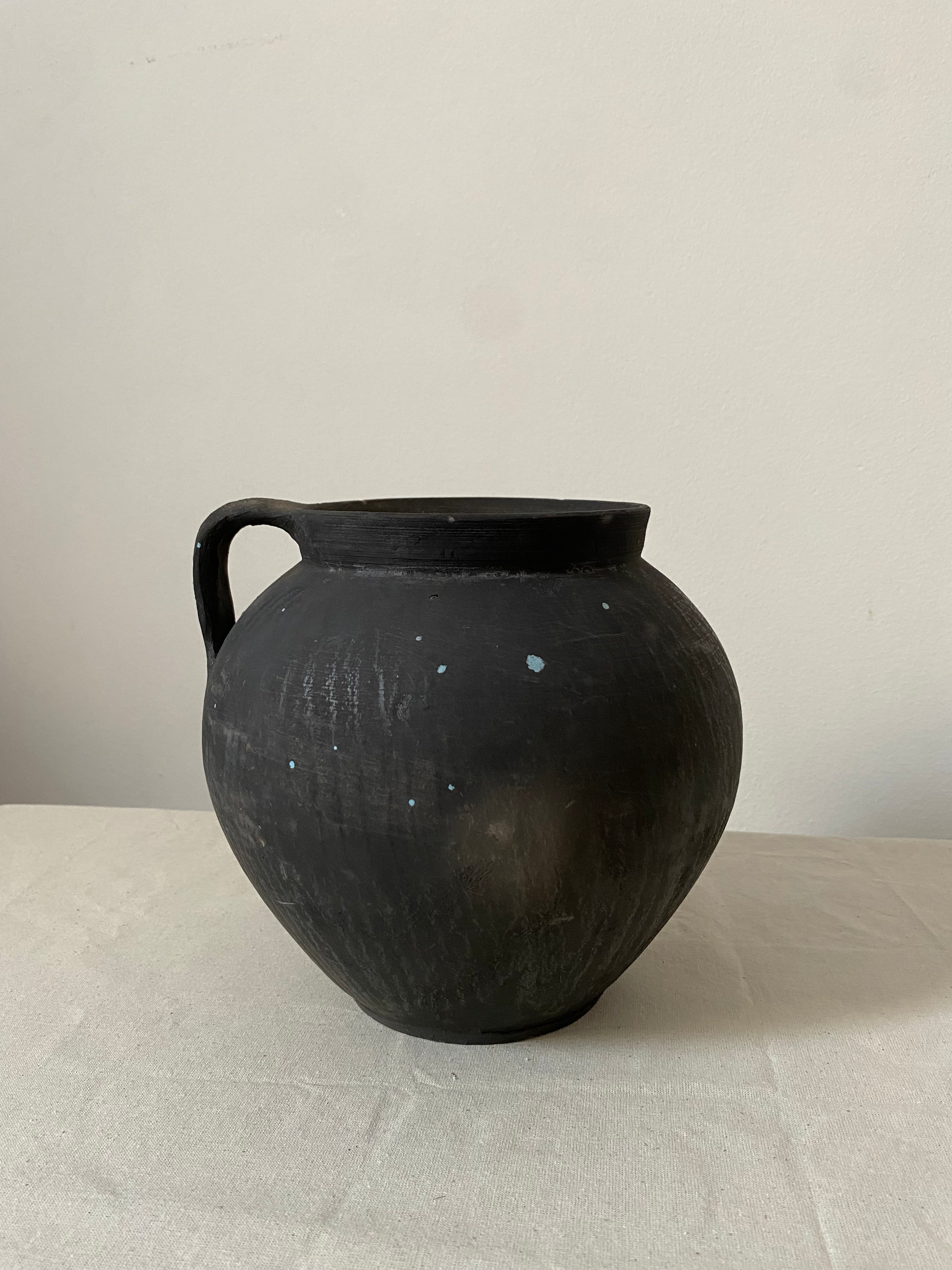 Black ceramic vase on a light gray background