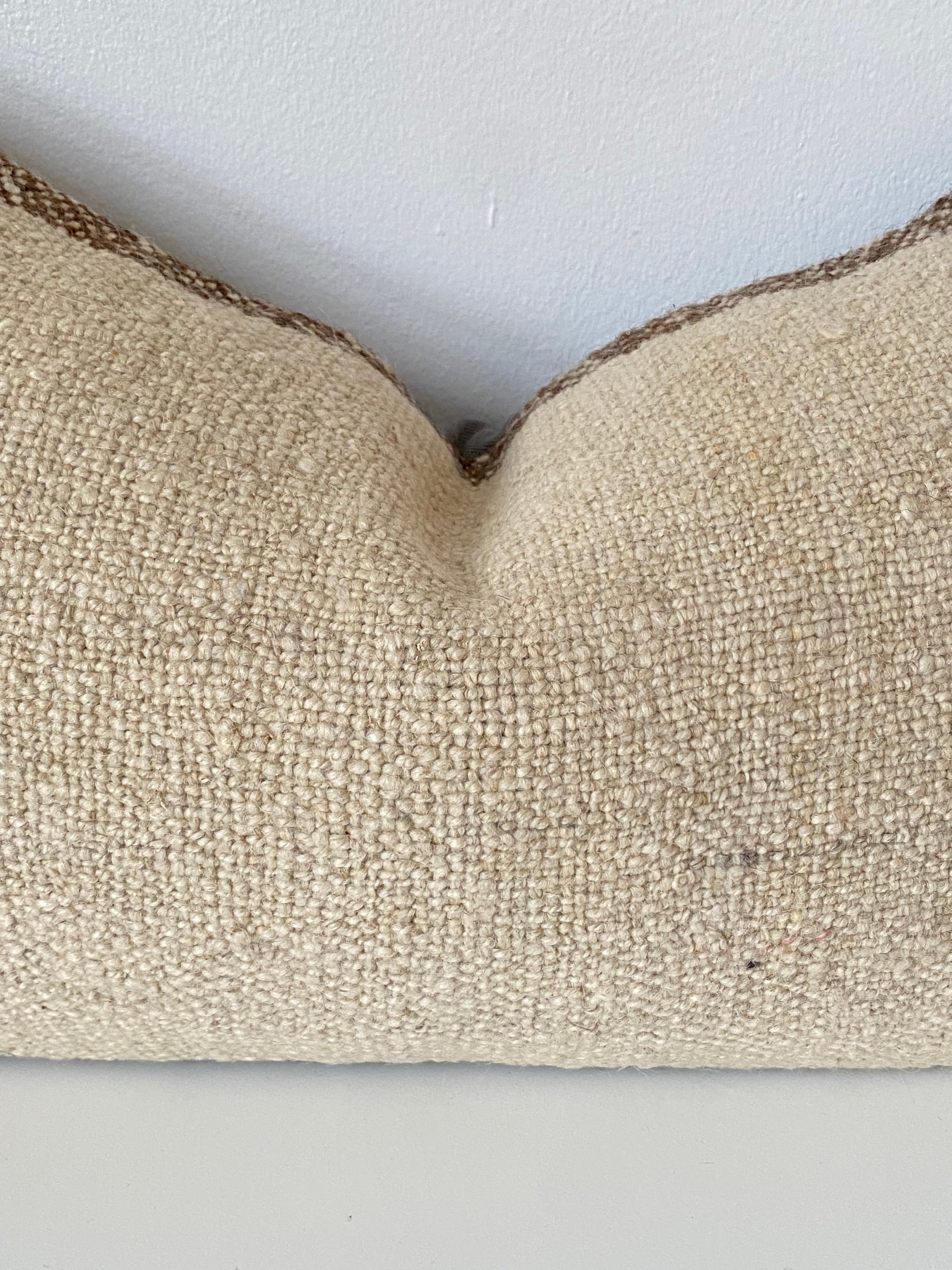 Textured beige Turkish Pillow cover on a white background