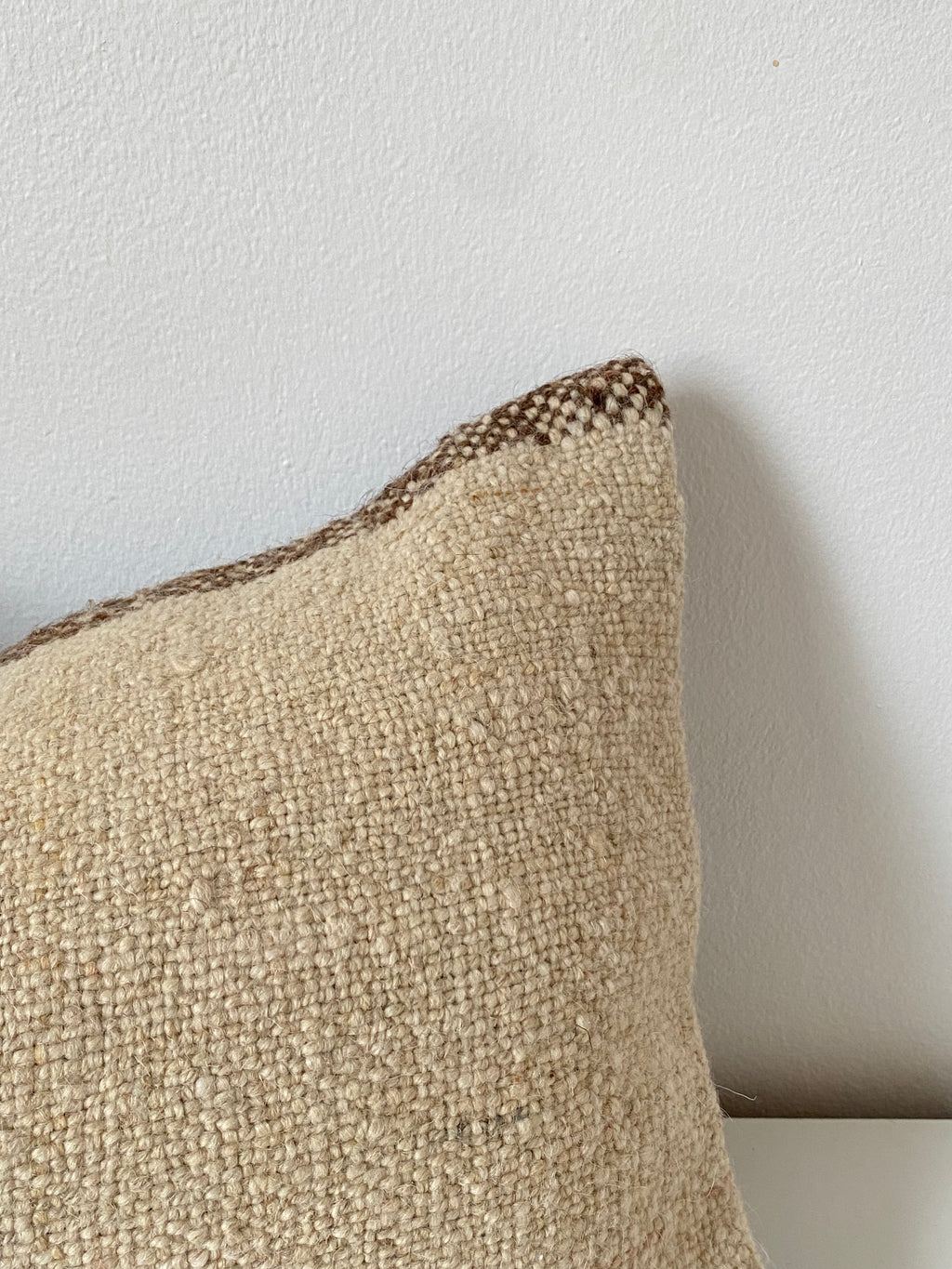 Textured beige Turkish pillow cover on a light grey background