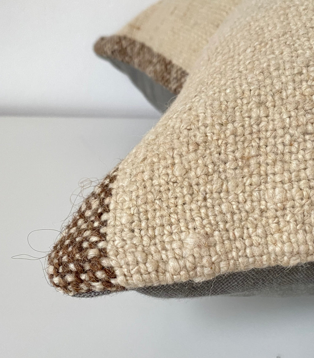 Close-up of a textured beige Turkish pillow cover with a white background