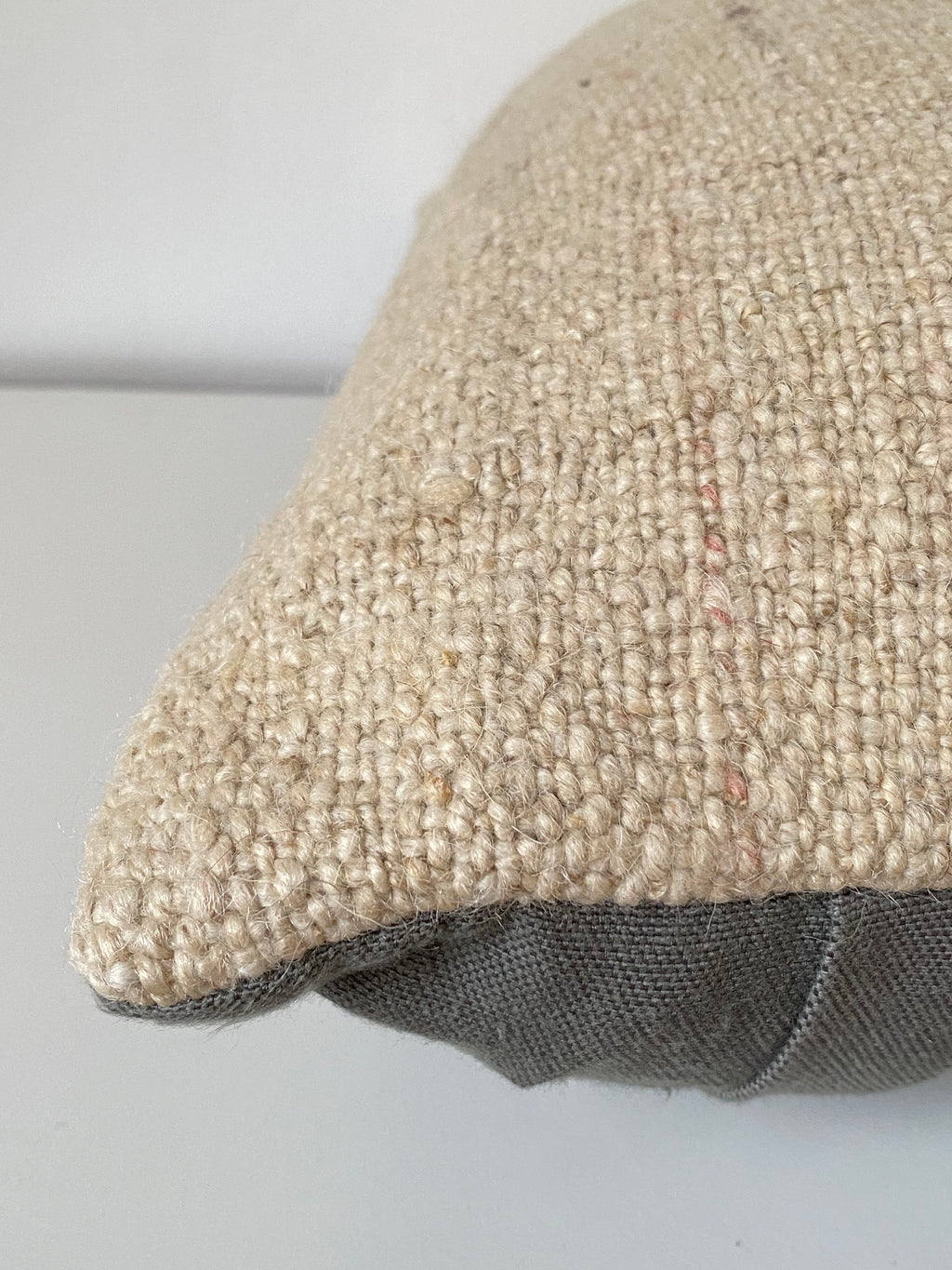 Textured Turkish Kilim Pillow cover with a visible brand name on a light grey background