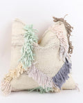 A square woven Turkish Kilim pillow cover in a natural beige tone with colourful fringe accents in mint green, dusty blue, cream, and taupe, set against a plain white background.
