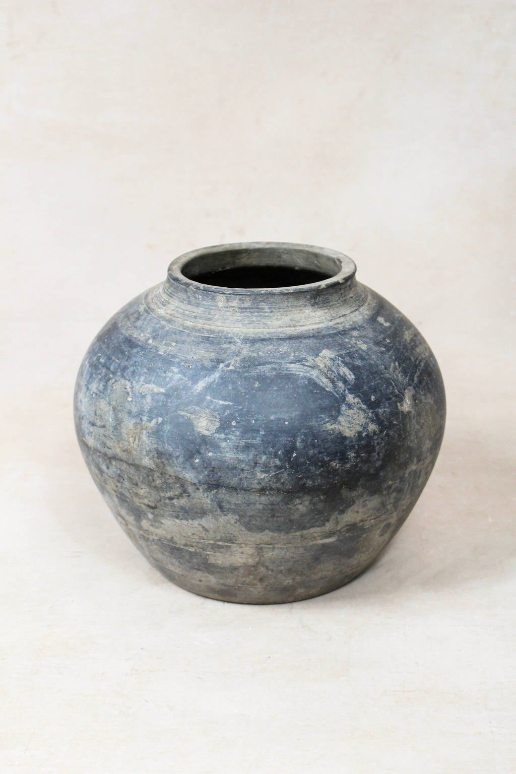Grey antique  clay vessel on a white background