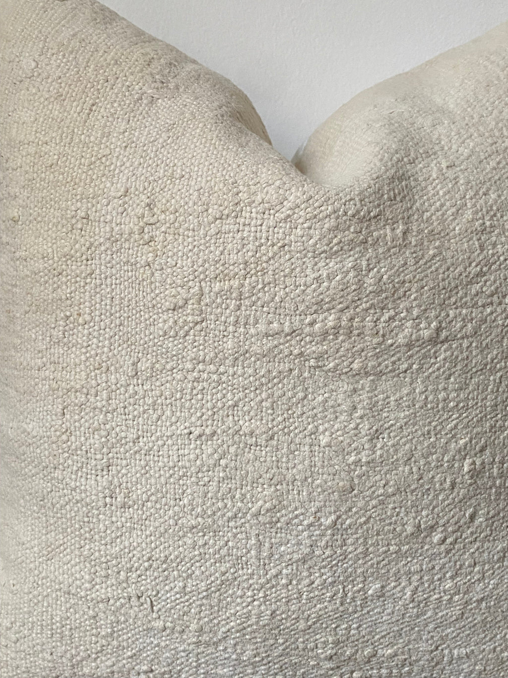 Close-up of textured off white fabric with a neutral background