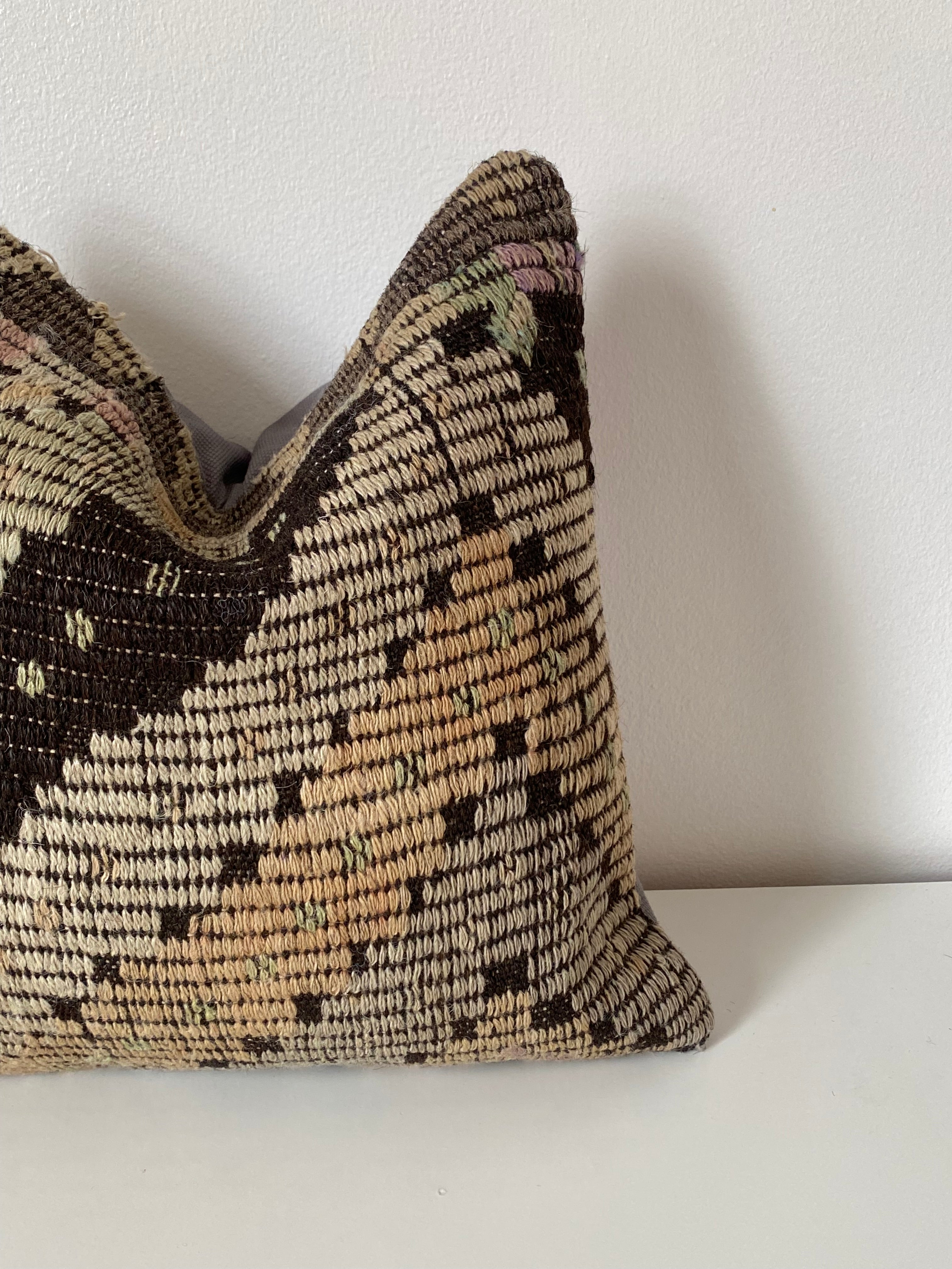 Textured Turkish kilim pillow cover with geometric pattern on a white sofa