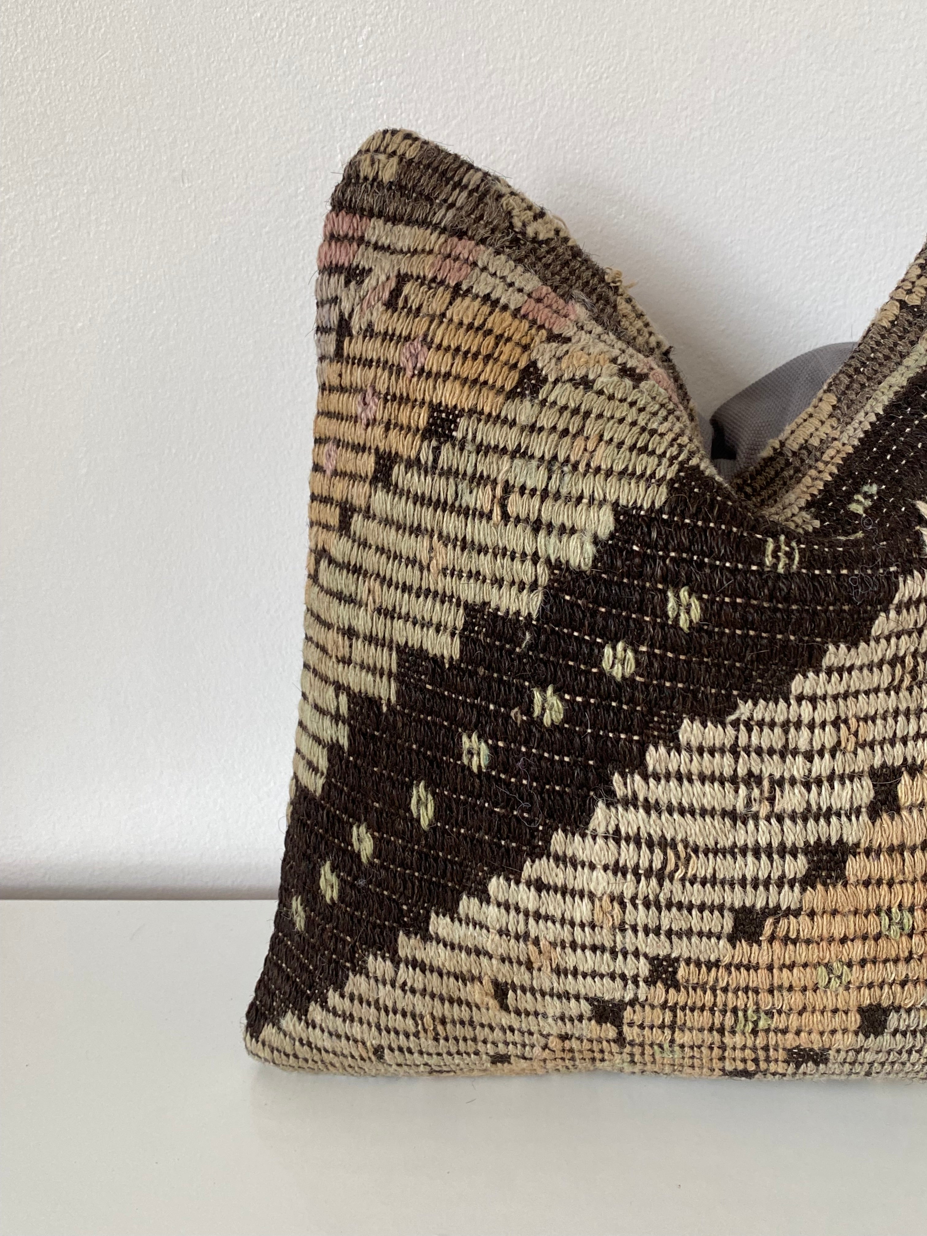 Textured Turkish kilim pillow cover with geometric pattern on a white background