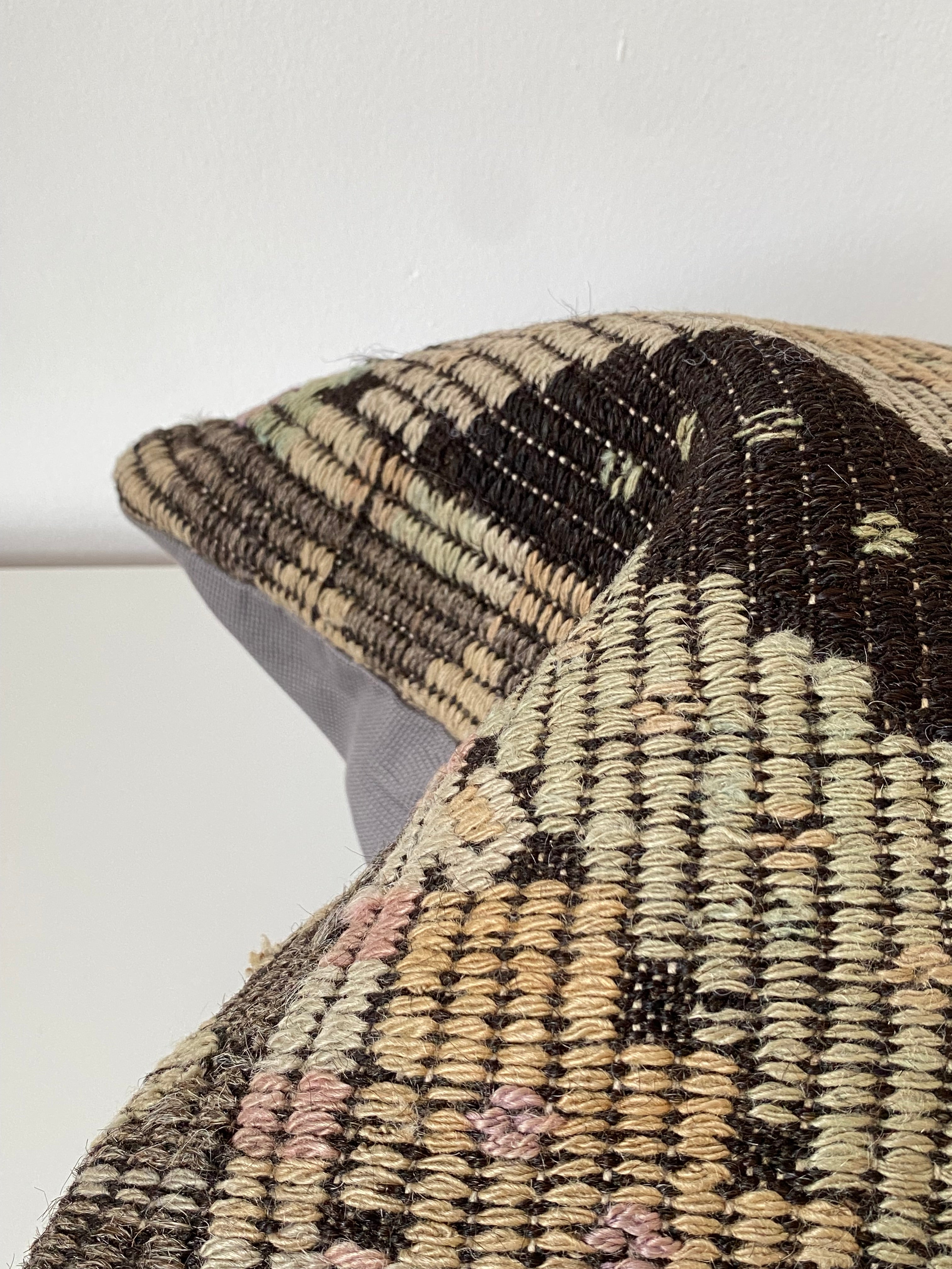 Close-up of a Turkish Kilim pillow cover handwoven wool with geometric pattern on a white background