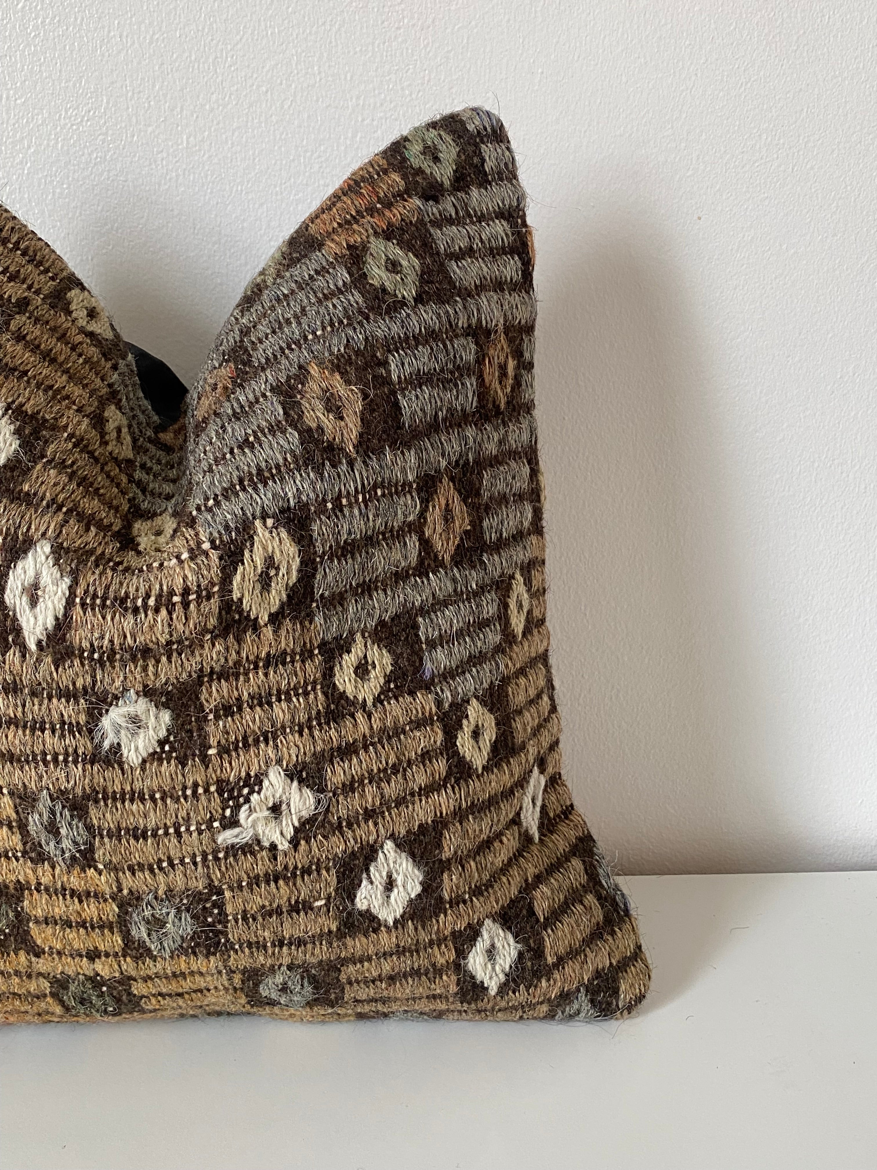 Textured Turkish Kilim pillow cover with a pattern on a white background