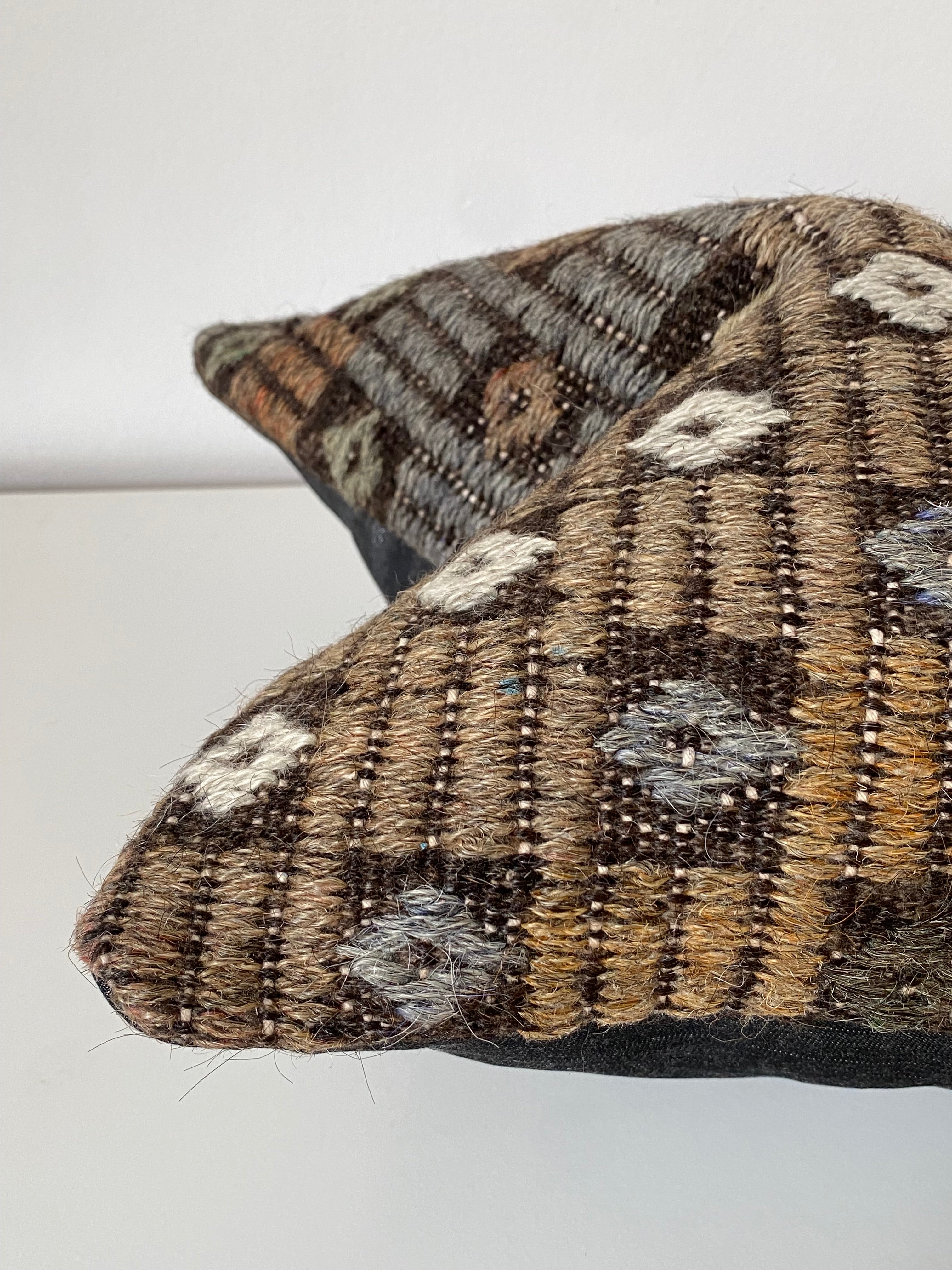Close-up of a Turkish Kilim Pillow Cover with geometric patterns on a white background