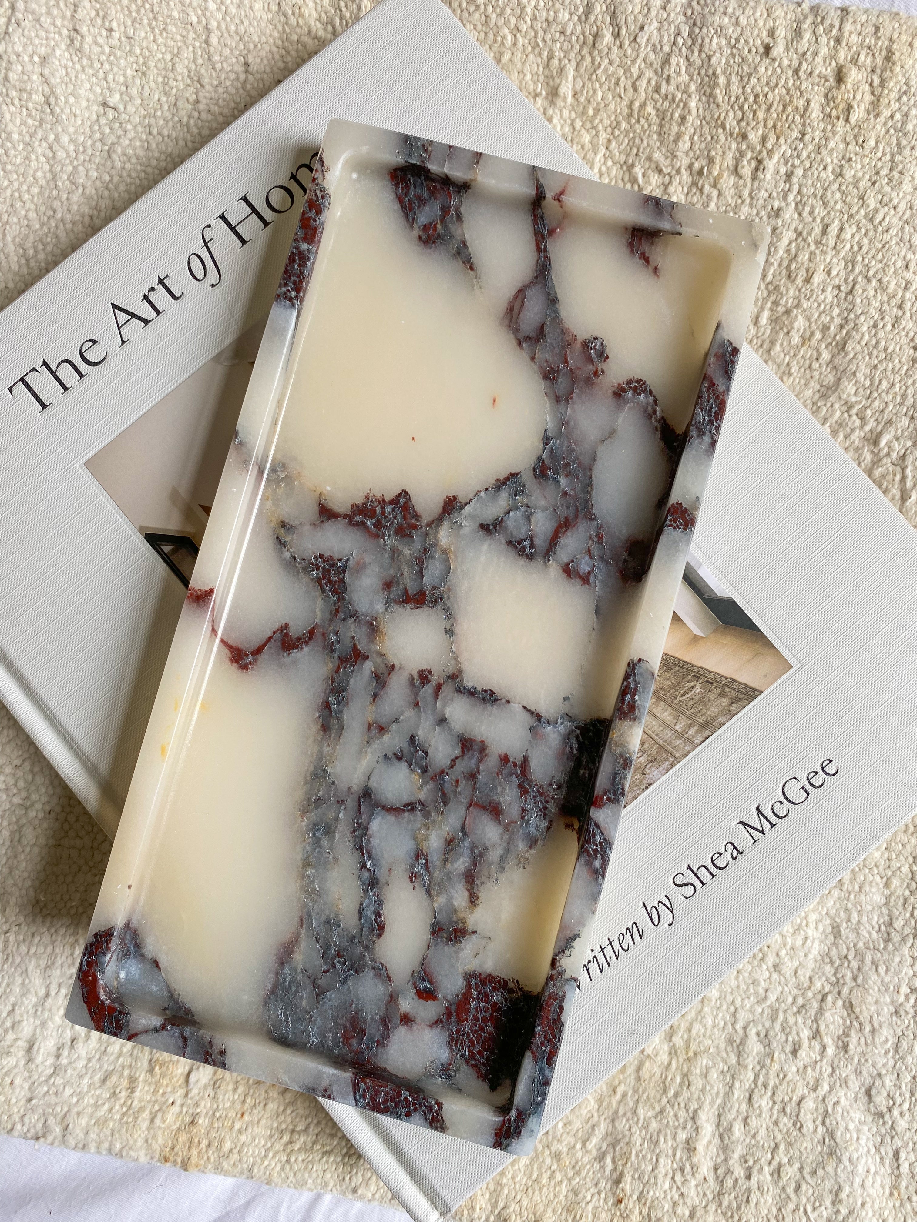 Rectangular Calcutta Marble-patterned tray on a book of The Art Of Home