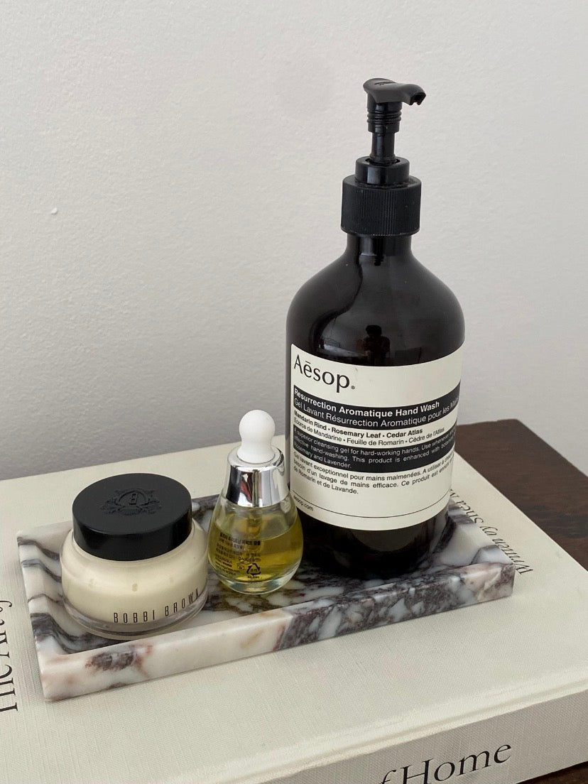 The Calacatta Viola Tray on a book 