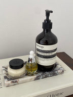 The Calacatta Viola Tray on a book 