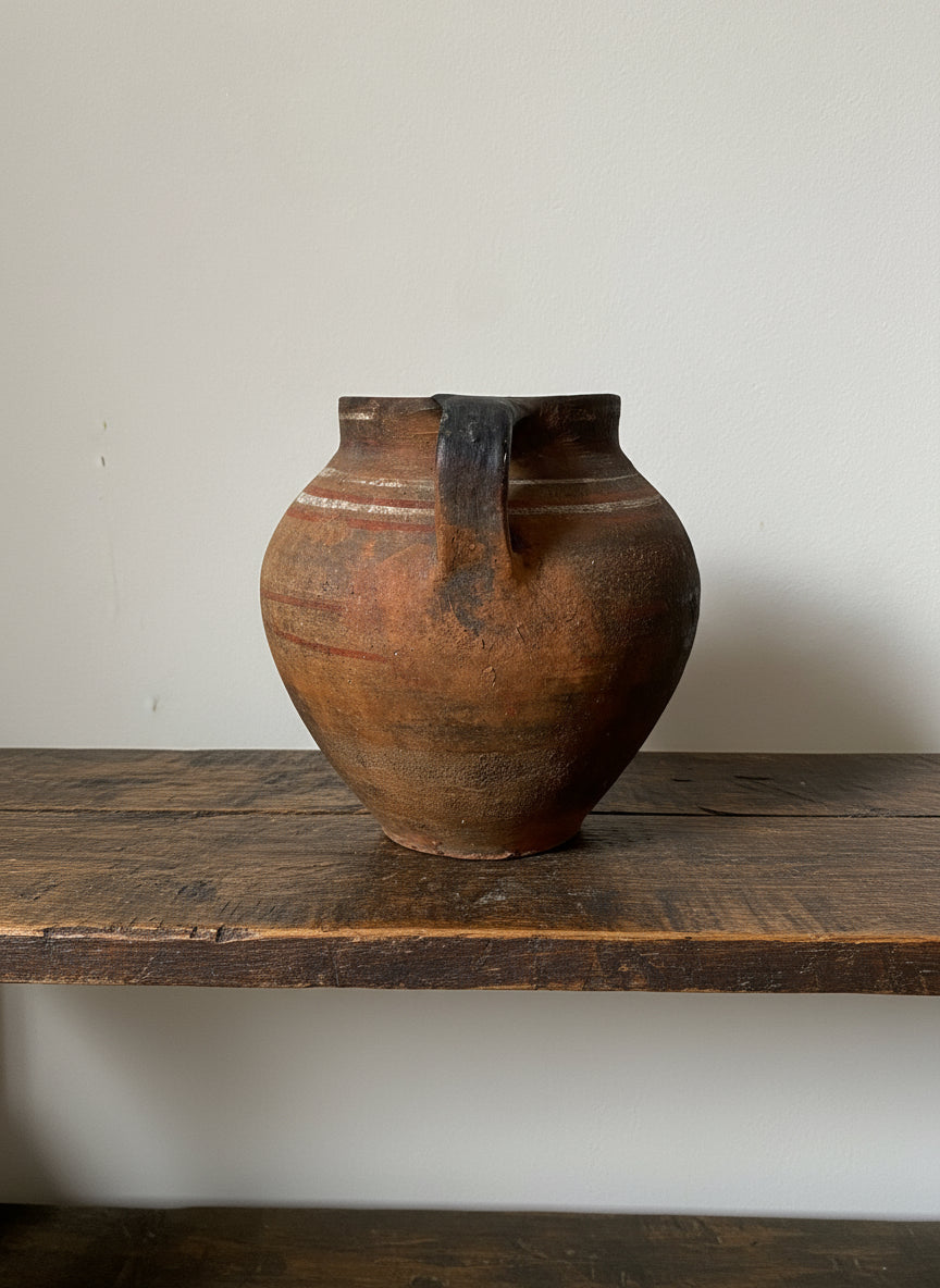 Brown ceramic vase on a light gray background